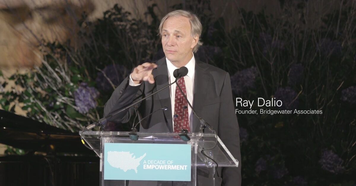 Ray Dalio speaking at a lectern during a 2017 Grameen America event