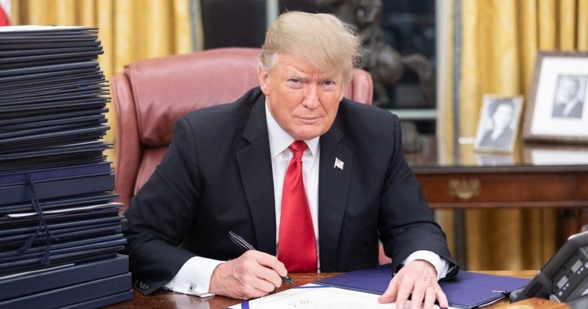 President Trump seated at the Resolute Desk