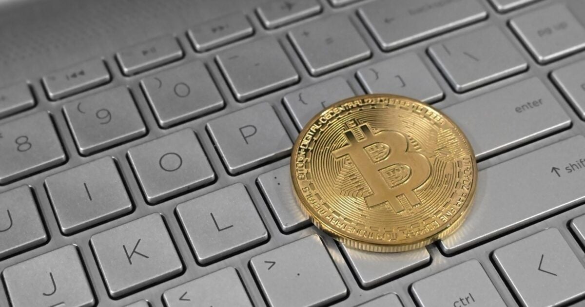 Physical bitcoin token resting on a laptop keyboard