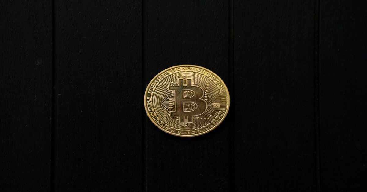 Physical Bitcoin coin representing the settlement layer in post-quantum verification research