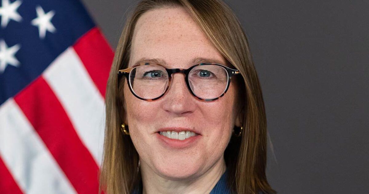 Official portrait of SEC Commissioner Hester Peirce in front of an American flag