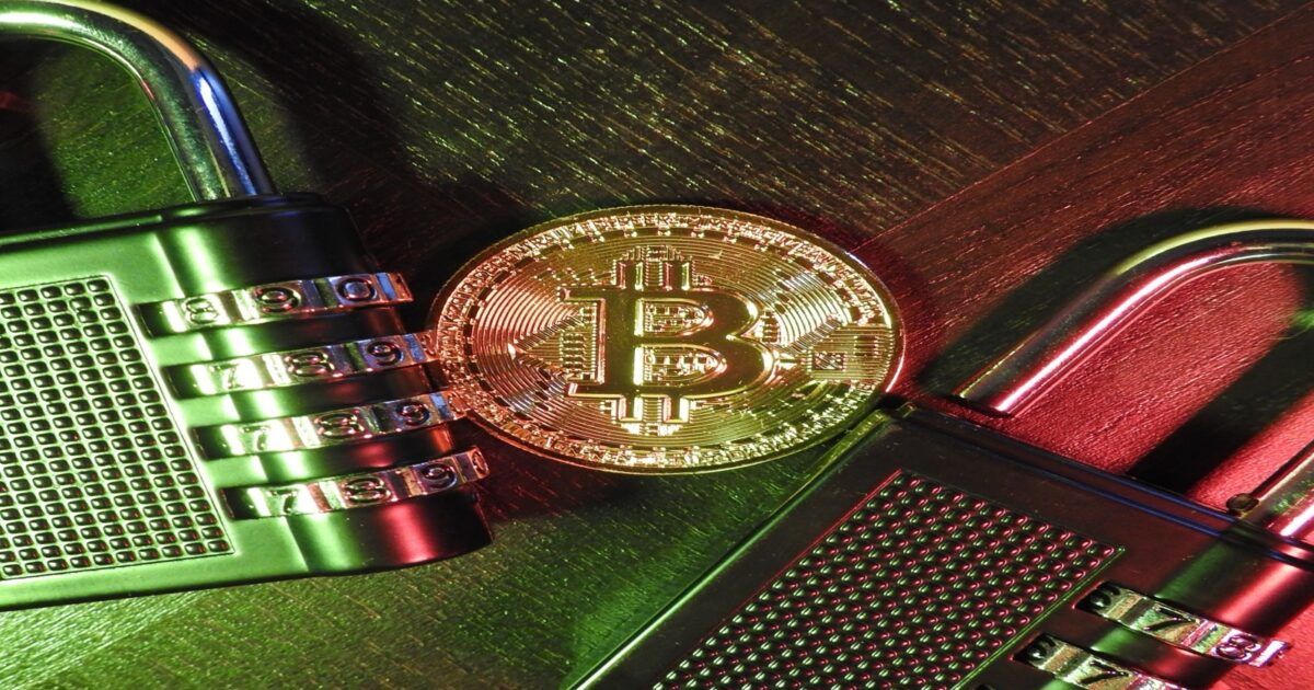Bitcoin coin positioned between two combination padlocks