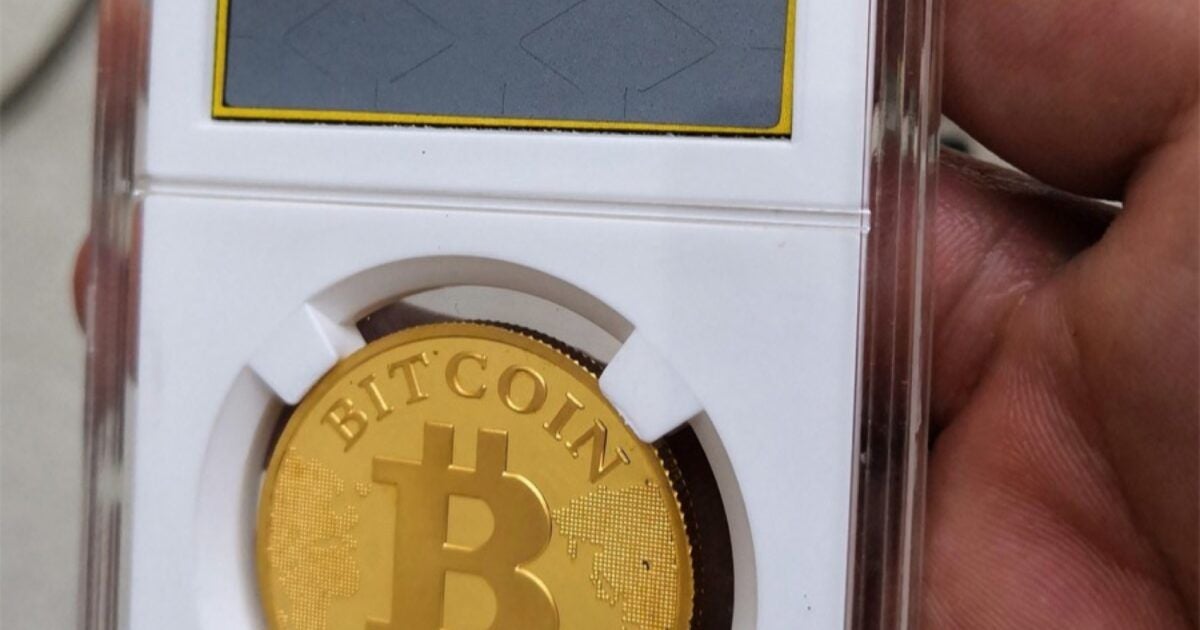 Gold physical Bitcoin in a holder during an ETF market analysis