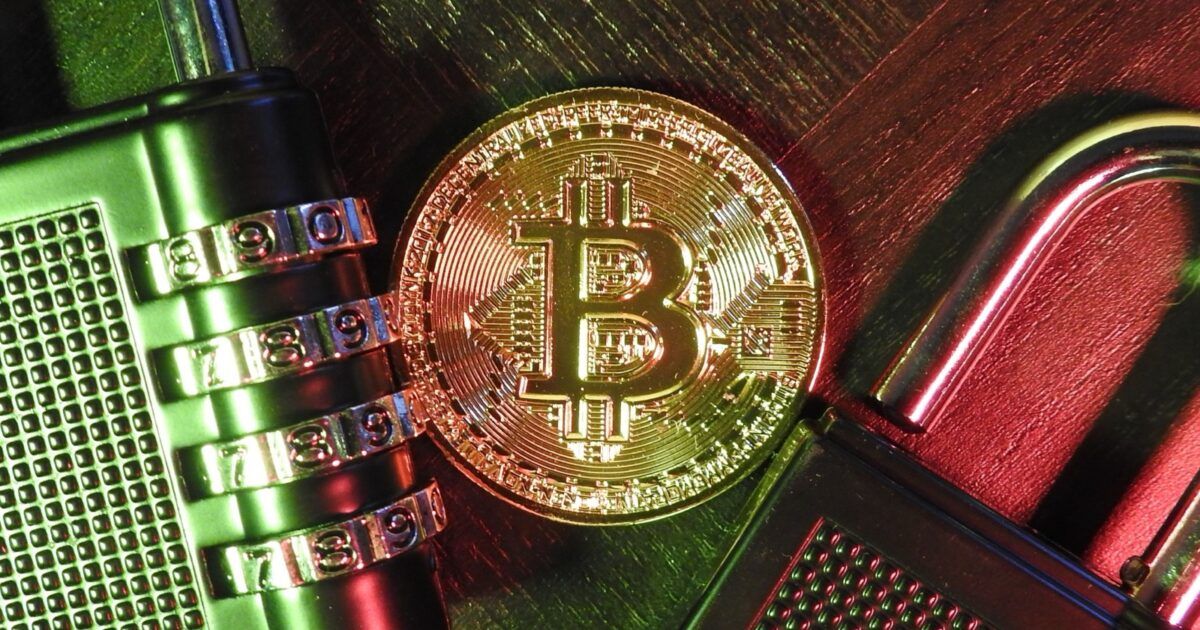 Physical Bitcoin coin surrounded by combination padlocks