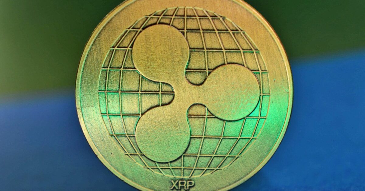 A close-up photograph of a physical XRP coin