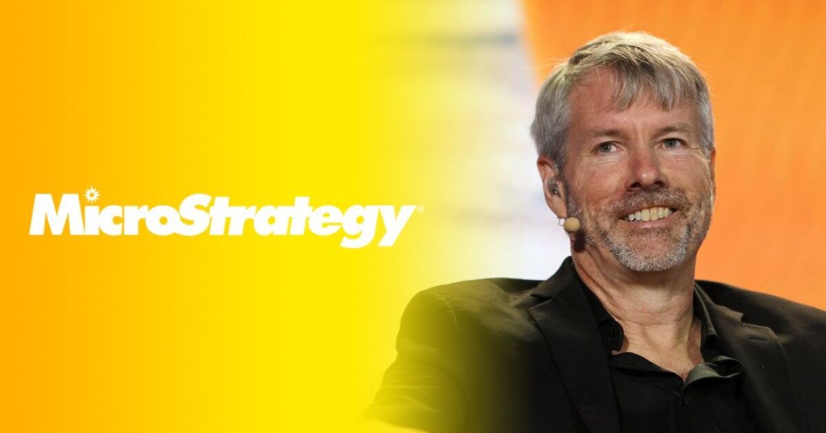 Michael Saylor at an event beside the MicroStrategy wordmark