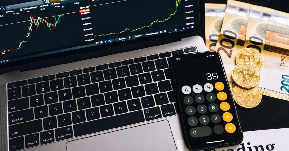 Bitcoin coins, Euro notes, calculator, and market screen representing Strive’s SATS capital raise